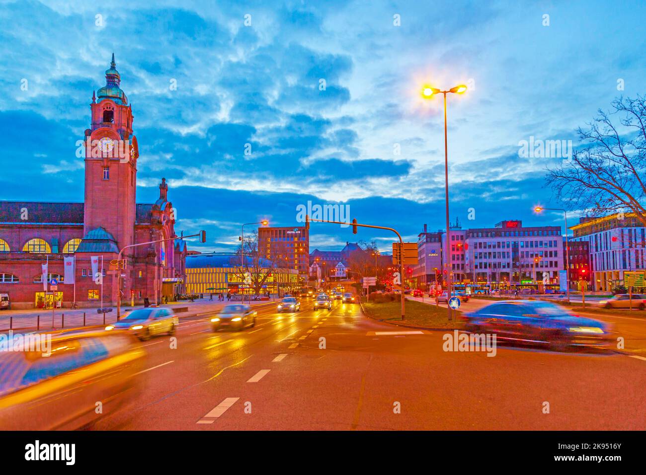 WIESBADEN, GERMANY JAN 12: evening traffic in front of the station on JAN 12,2013 in Wiesbaden , Germany. The  Railway Station, a prime example of His Stock Photo