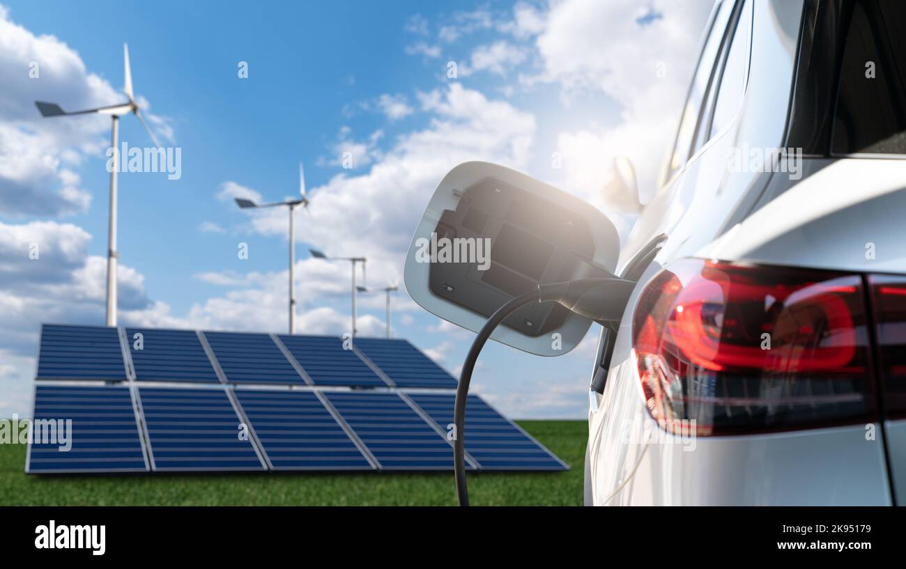 Close up of electric car with a connected charging cable on the background of solar panels and