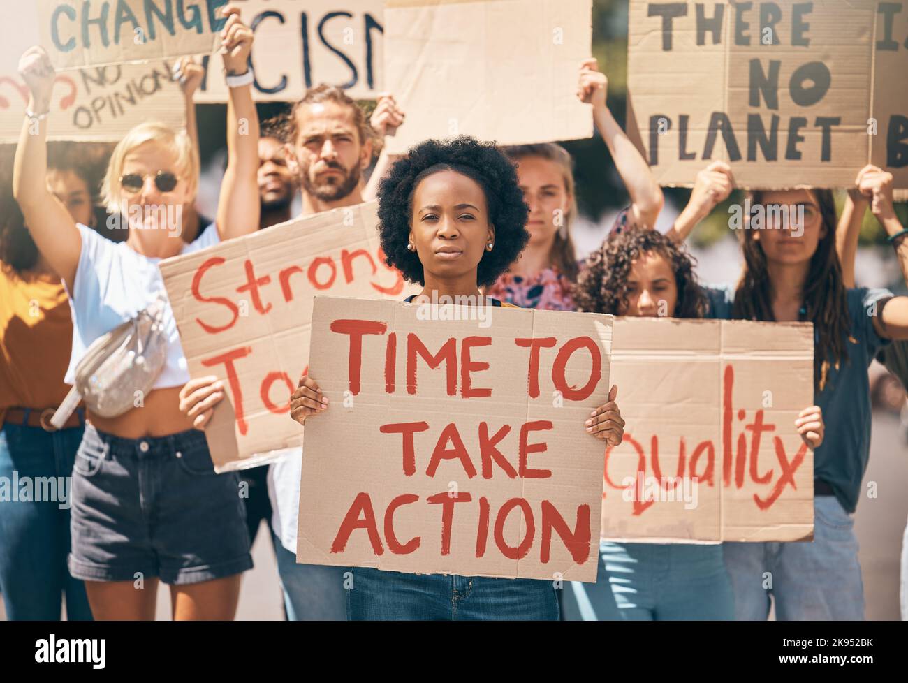 Group, protest and portrait in street, poster or climate change with march, walking or together for change. People, diversity or action in activism Stock Photo