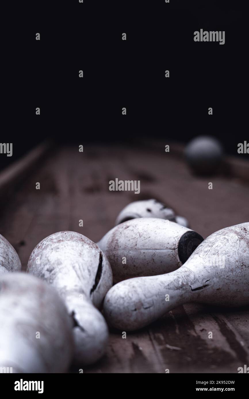A vertical closeup of dirty broken bowling pins outdoors at Pavliani