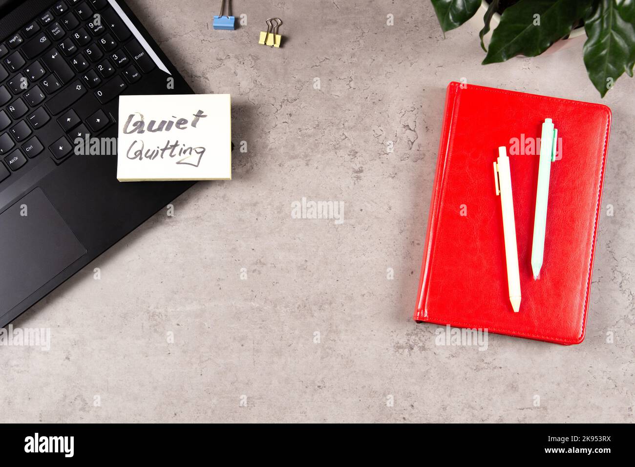 Quiet Quitting. Workplace desk with office supplies, potted plant