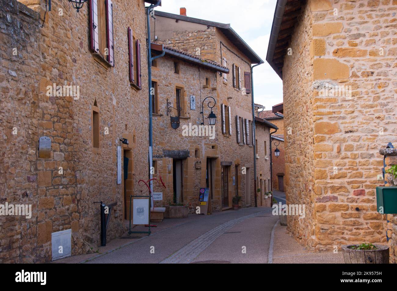 A beautiful alley with historic brick stone buildings in Oingt, France Stock Photo