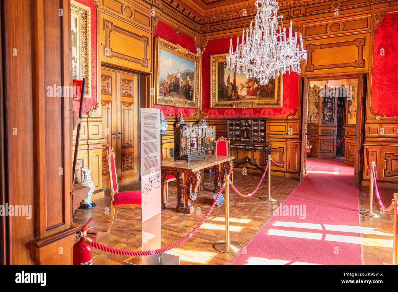 A room with furniture and portraits inside Miramare Castle near Trieste, Italy Stock Photo