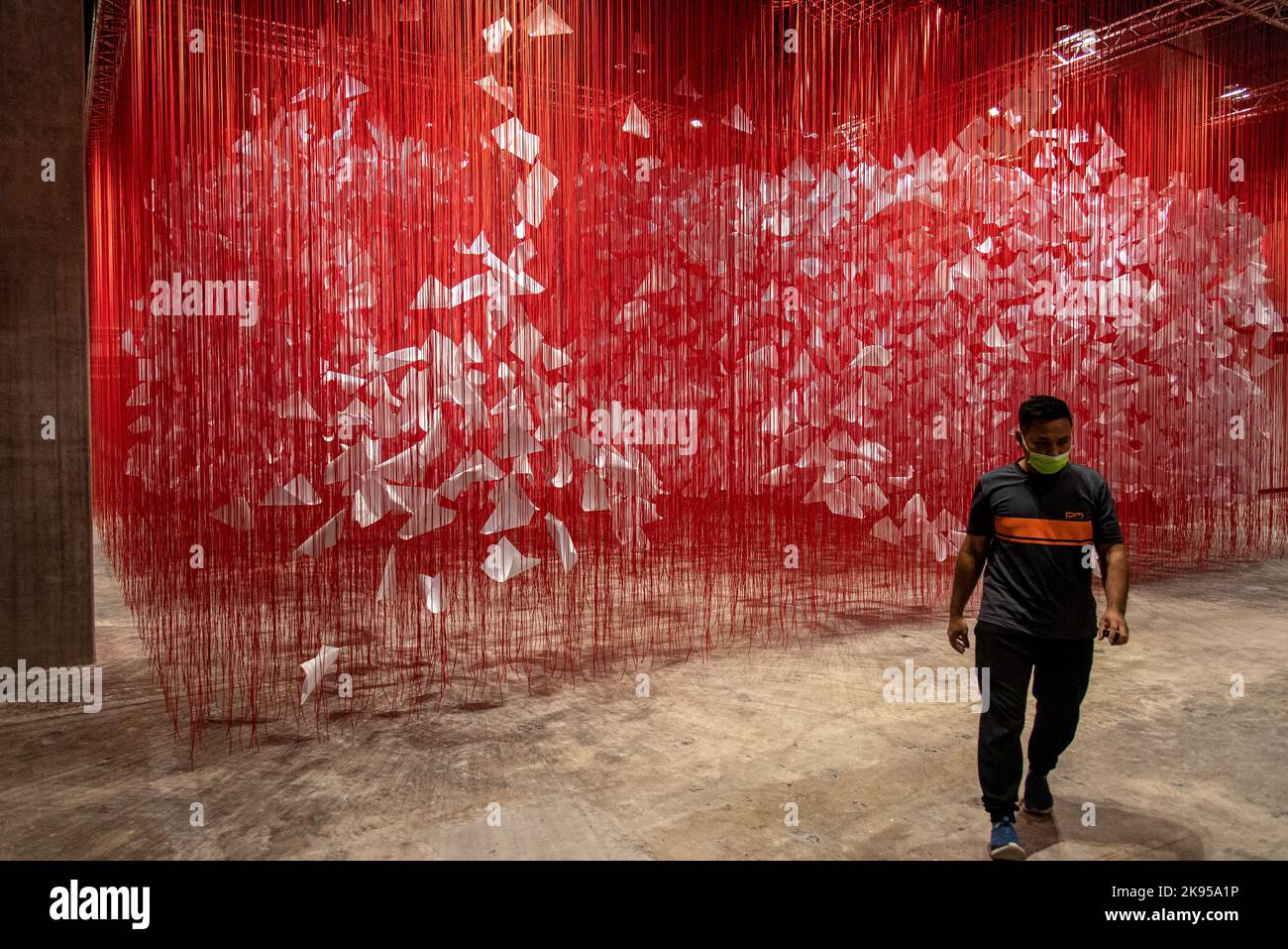 A visitor seen walk past an artwork by Japanese artist Chiharu Shiota