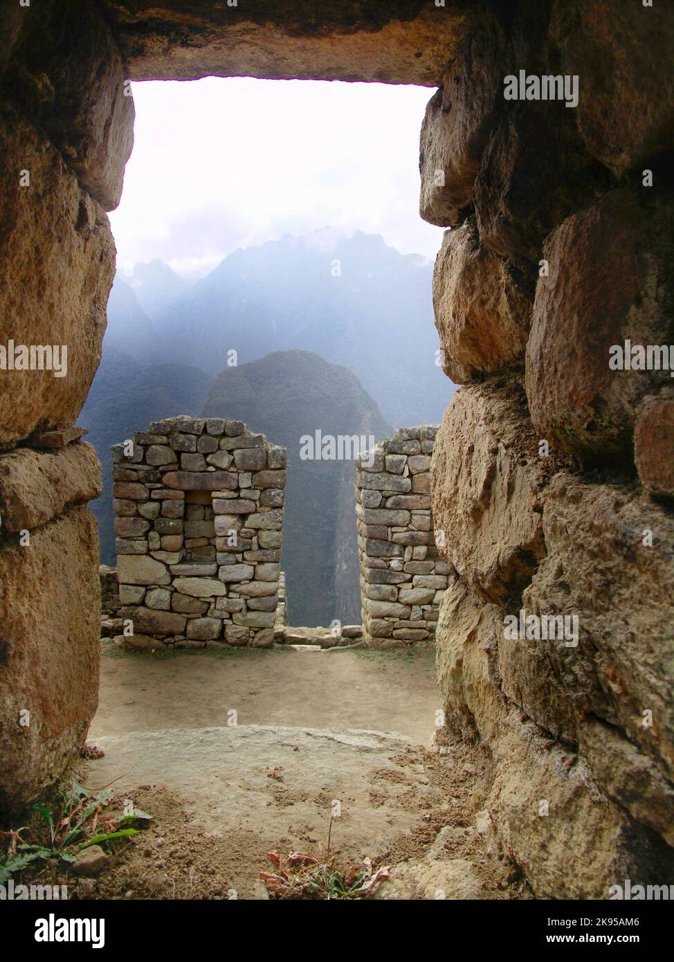 A vertical shot of the historic Machu Picchu citadel ruins in the Andes ...