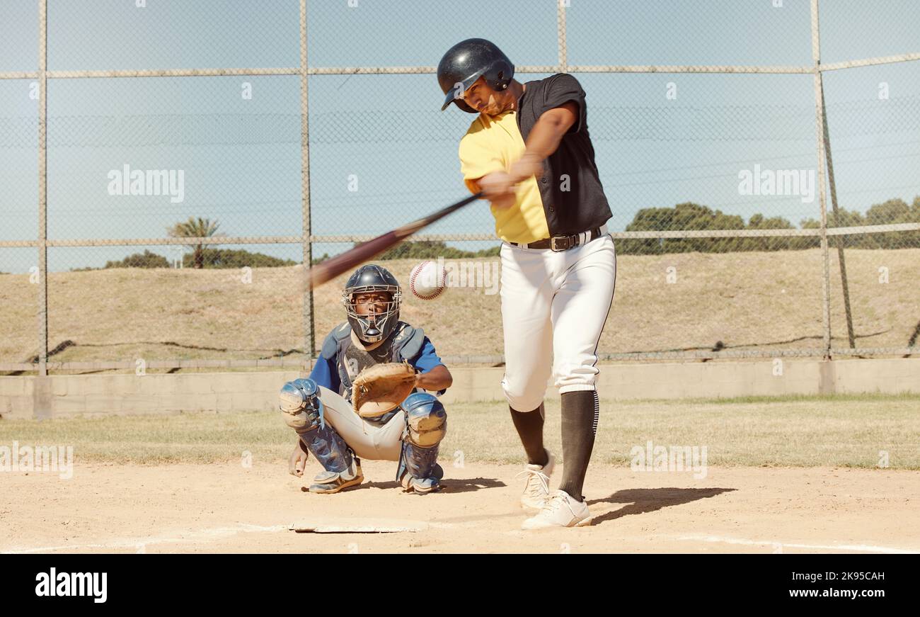 Sports man, field and baseball player strike ball in game competition, practice or bat training workout. Softball pitch, health performance and Stock Photo