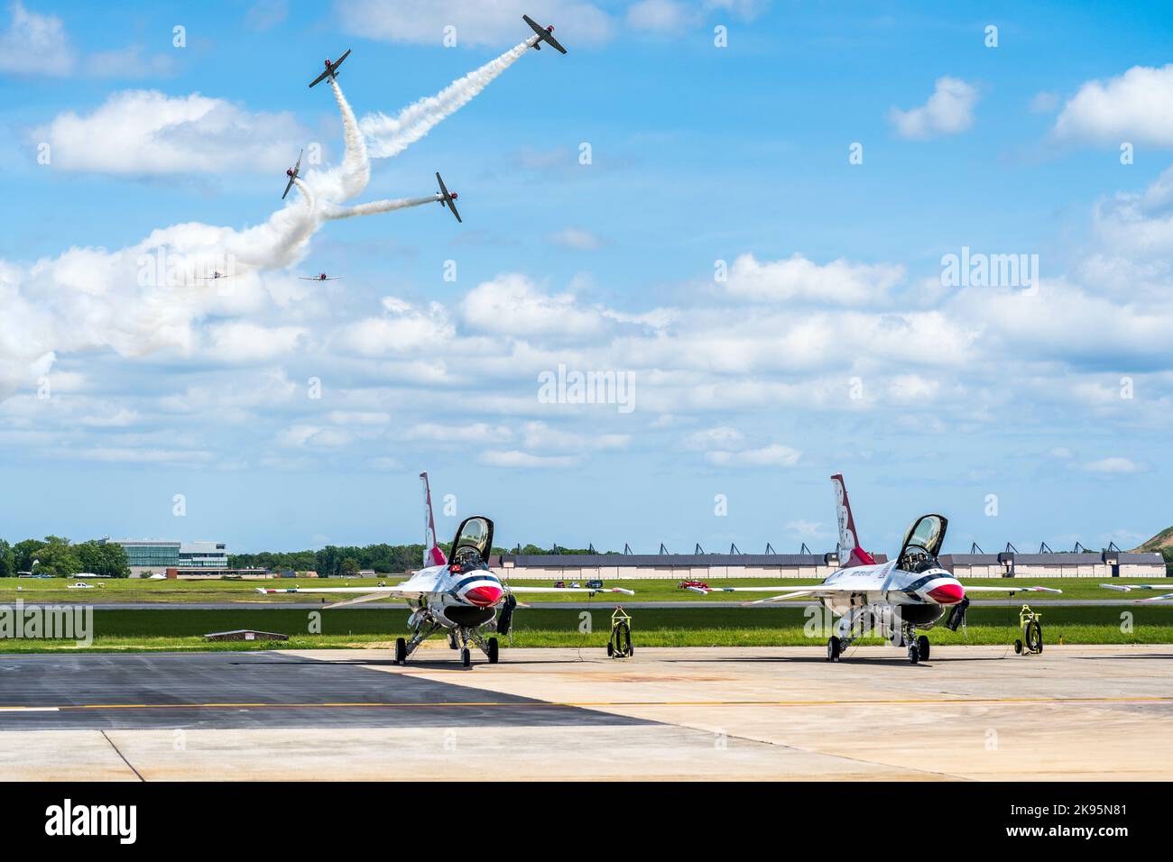 Many US Airforce Thunderbirds military Airplanes performing in an airshow with sunlight Stock Photo