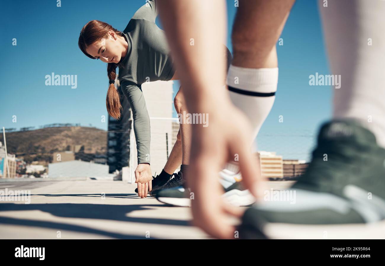 Zoom of hands, woman stretching legs or runner shoes with friends for running exercise, fitness or marathon workout. Health, training or wellness Stock Photo