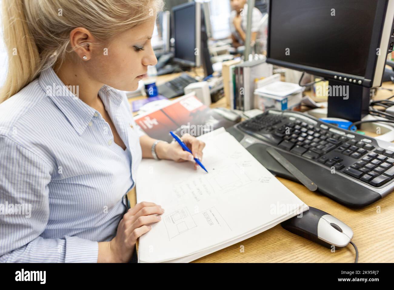 The Media Agency: Making Notes. A female media professional researching ...