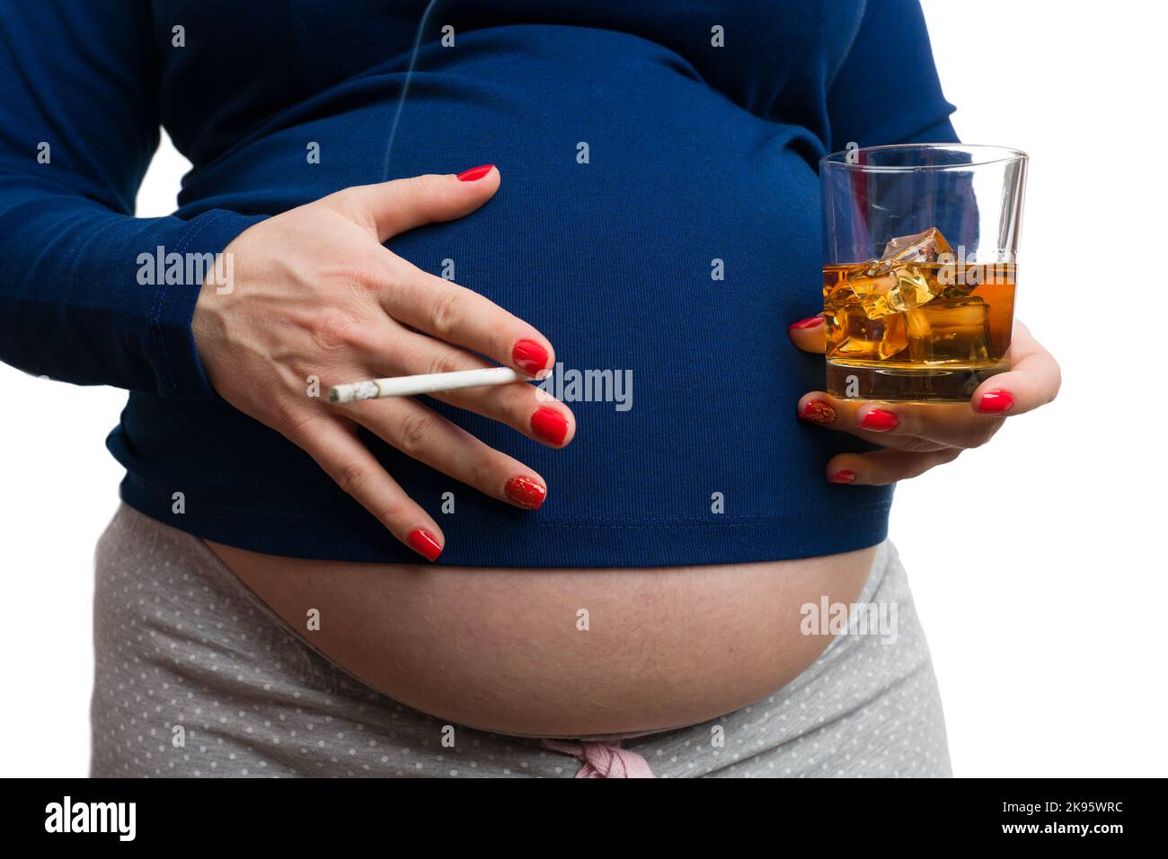 Closeup of pregnant woman holding cigarette and whiskey isolated on white background as