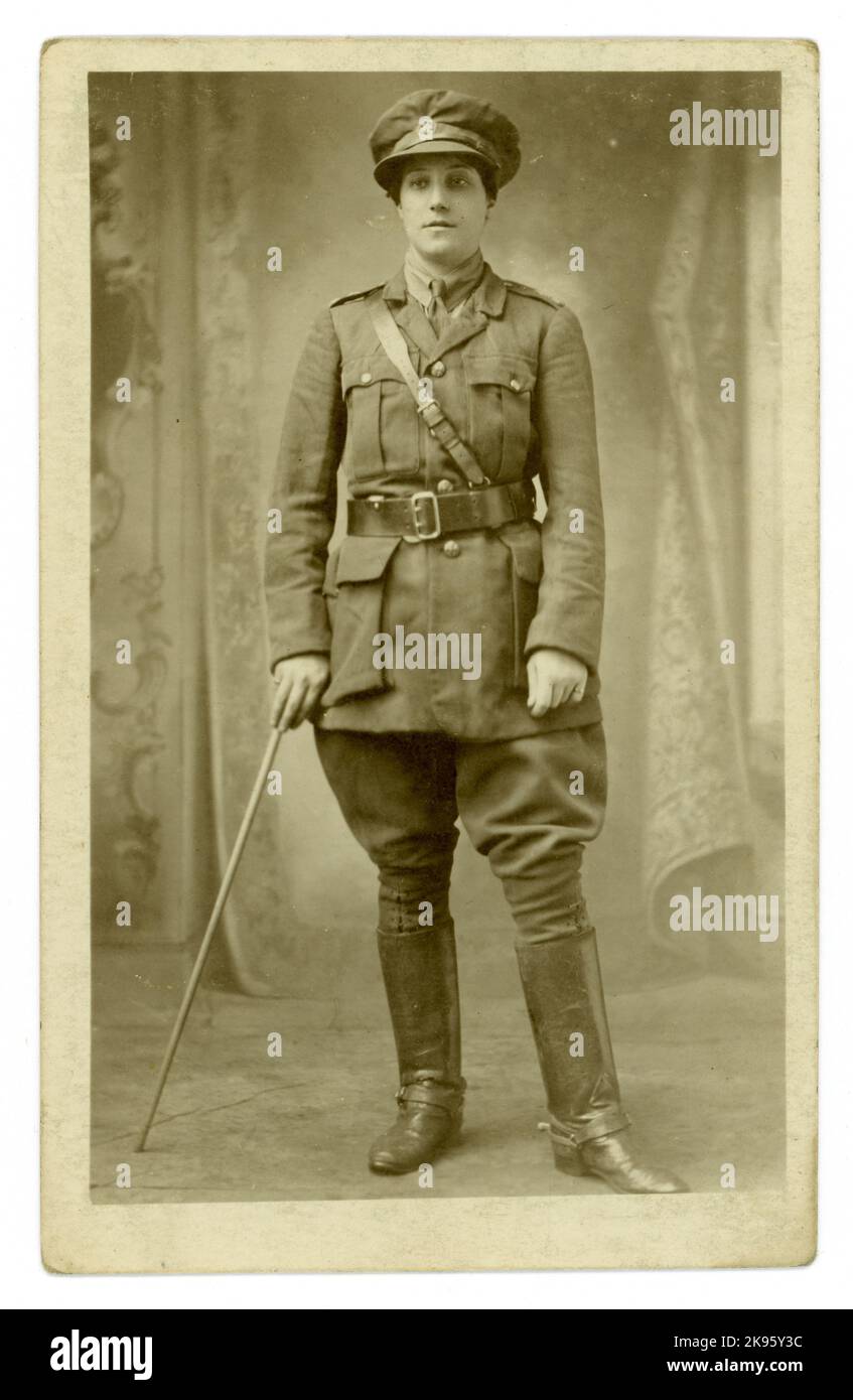 Original WW1 era studio portrait postcard, of attractive woman in khaki uniform -  possibly a woman rider of  Women's First Aid Nursing Yeomanry corps, (FANY),  who provided medical support, (some were mounted),  Bungay, Suffolk, England, U.K. circa 1915 Stock Photo