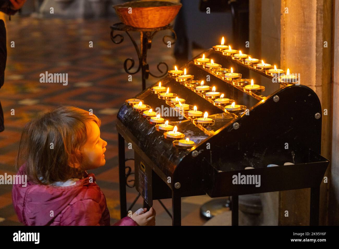 Ireland Dublin St Patrick's Cathedral Church of Ireland was Catholic founded 1191 Gothic young child toddler fascinated devotional candles Stock Photo