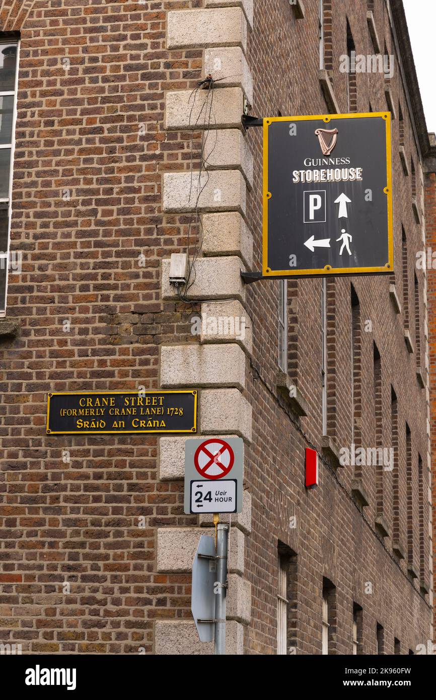 Republic of Ireland Eire Dublin street scene wall mounted signs Guinness Storehouse factory museum parking pedestrians Crane Street Crane Lane 1728 Stock Photo