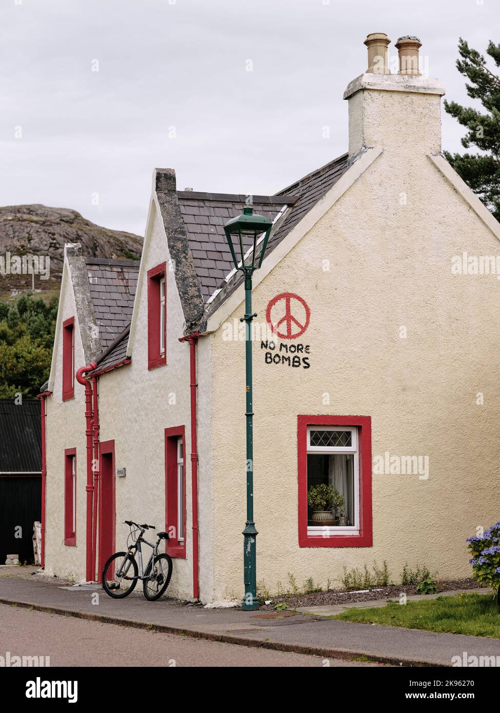 No More Bombs ! - a painted sign on a house in Shieldaig village in Wester Ross, Scotland UK. Stock Photo