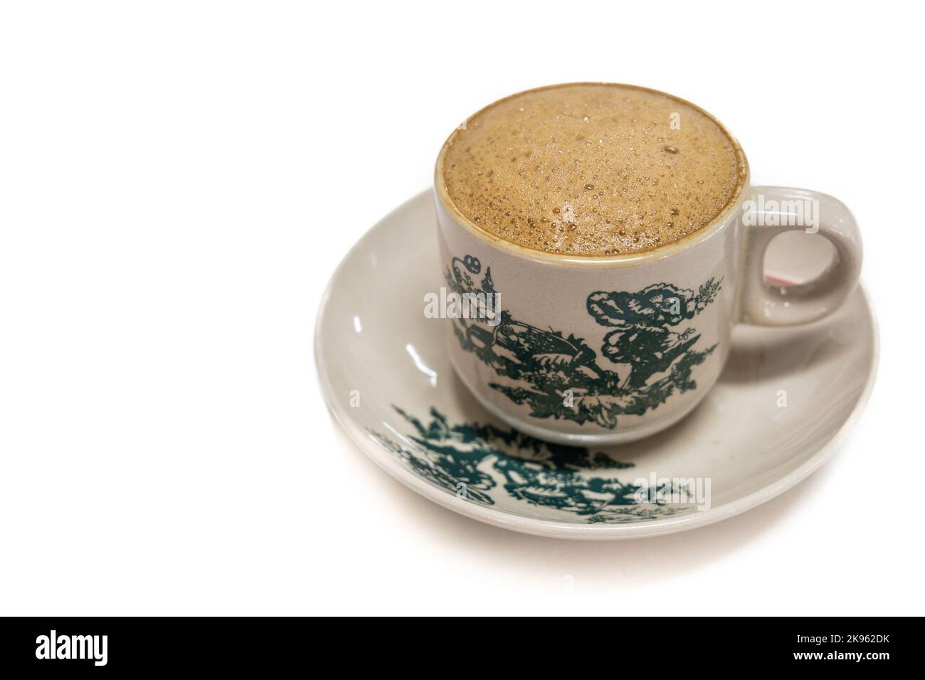 Tradiitional aromatic coffee served in vintage kopitiam cup and saucer in white background Stock Photo