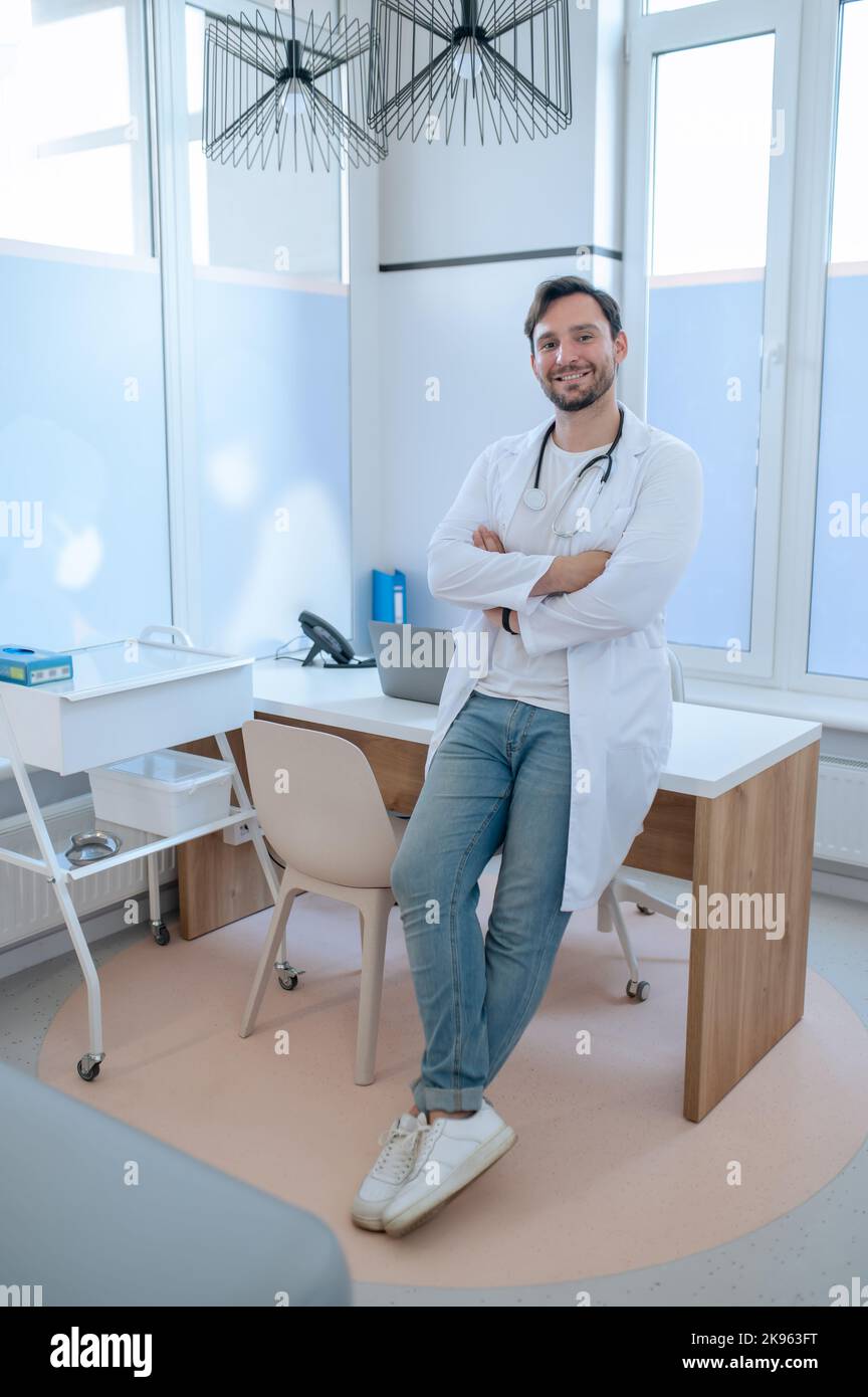 Nice friendly doctor sitting hi-res stock photography and images - Alamy