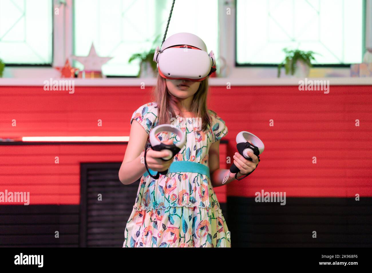 vr game and virtual reality. kid girl gamer eight years old fun playing on futuristic simulation 