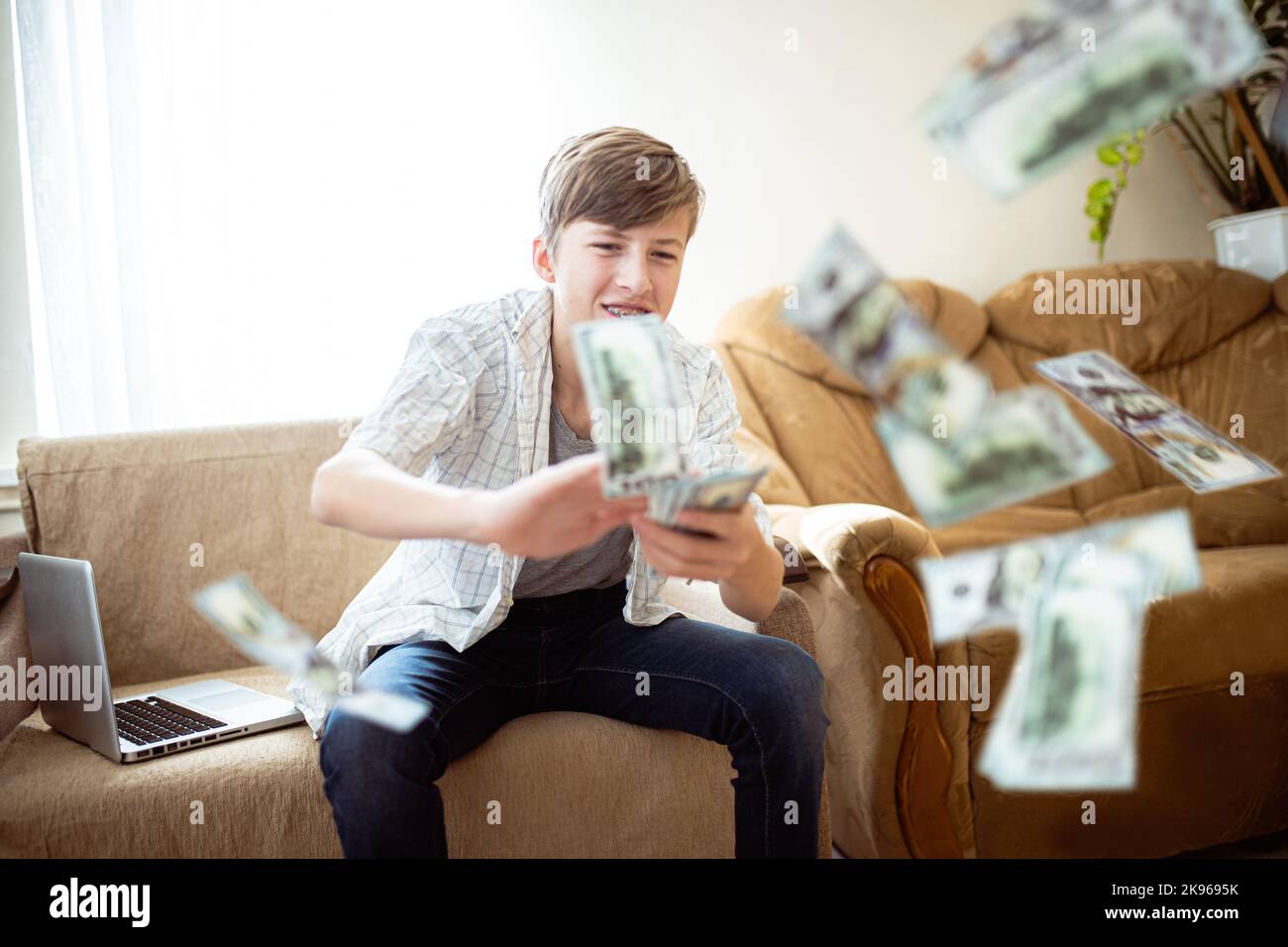 Generation z teenager wastes money by scattering it while gaming on
