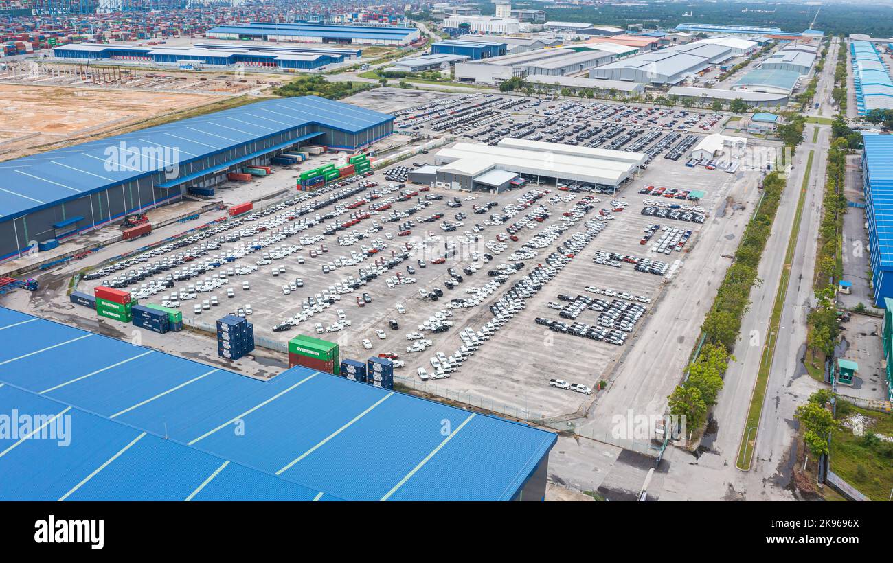 Klang, Malaysia-October 9, 2022: Automobile and car parking lot for commercial business industry. Aerial view new car lined up in port for import and Stock Photo