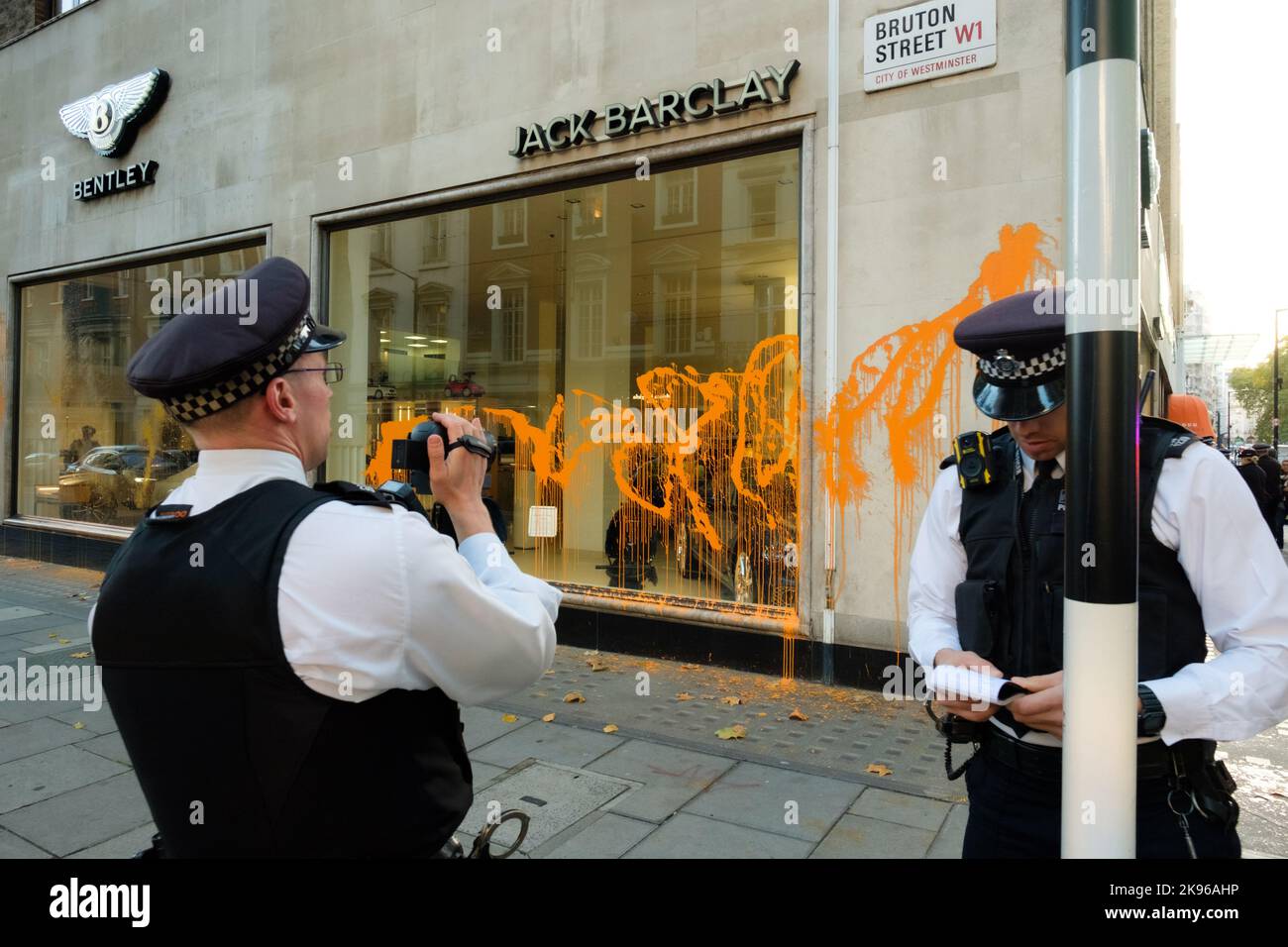 London, UK. 26 OCT 2022. A couple of Just Stop Oil activists spray-paint luxury car dealership in Mayfair. The climate protesters targeted H.R. Owen, Jack Barclay Bentley, and Ferrari Mayfair. Stock Photo