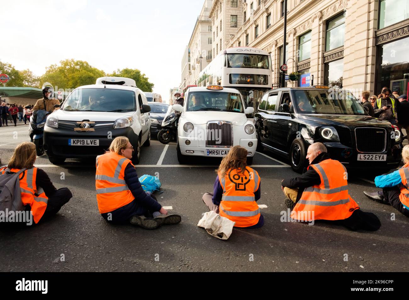 London, UK. 26 OCT 2022. Just Stop Oil activists block Piccadilly rd. by green park tube station. Angry drivers dragged some of the protesters and the pollice arrested them. Stock Photo