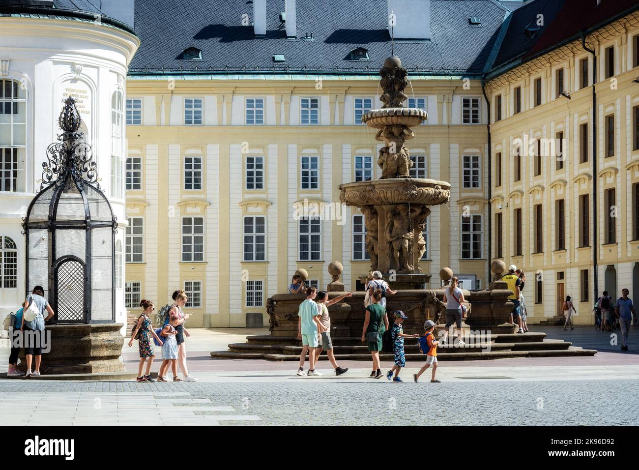 Prague, Czech Republic, July 28: Tourists get acquainted with the sights of the Prague Castle courtyard with a well and a fountain, July 28, 2022. Stock Photo