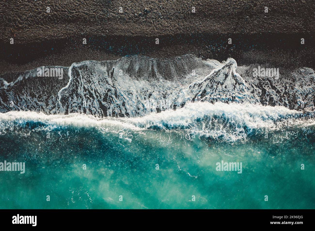 An aerial top view of sea waves splashing on the seashore in North Evoia, Greece Stock Photo