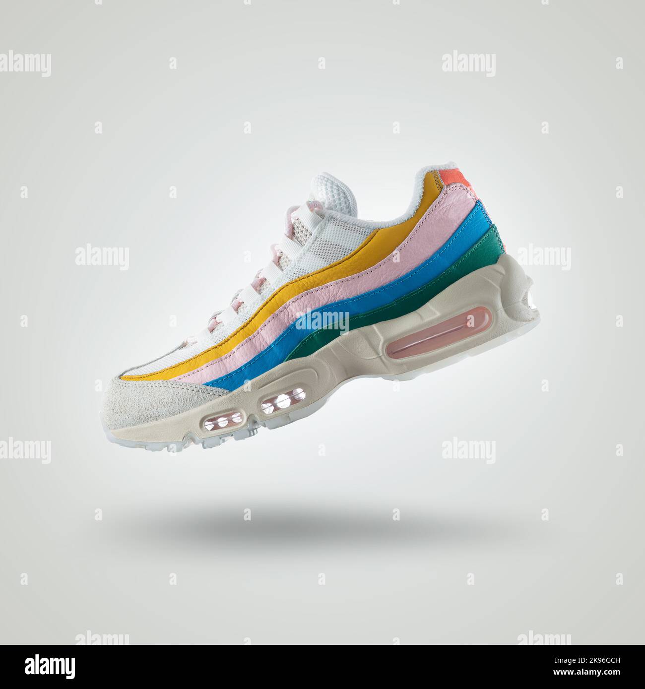 White sneaker with a diversity of colors, shoe on a white gradient