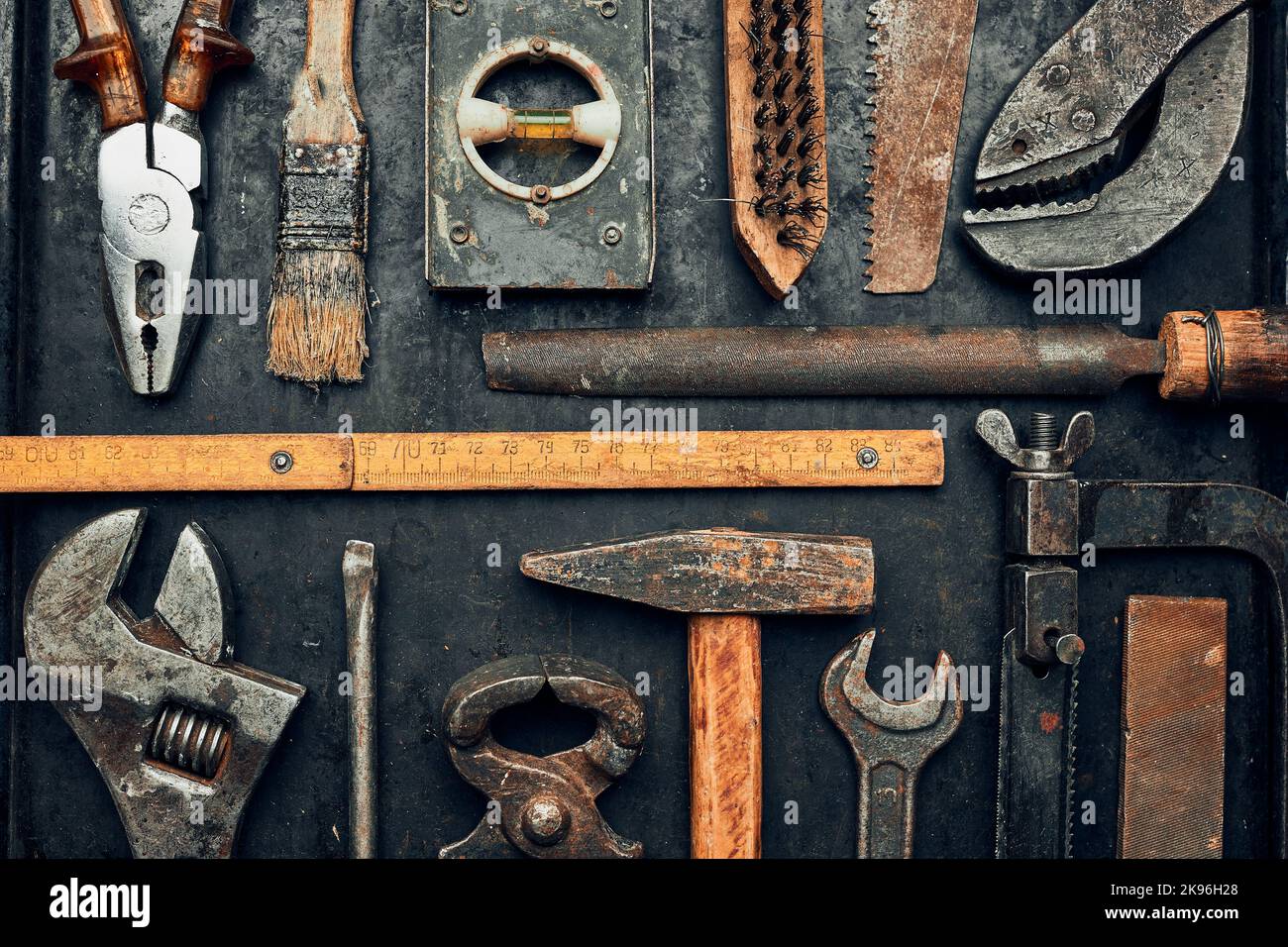 Old hardware tools. Wrench, screwdriver, measure, hammer, pliers on