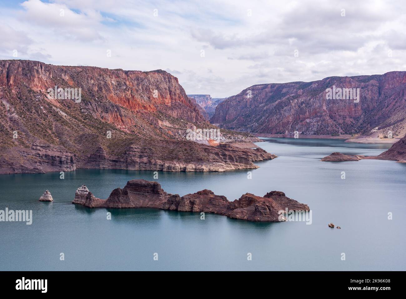 A cinematic lake surrounded by red cliffs in Provincia de Mendoza