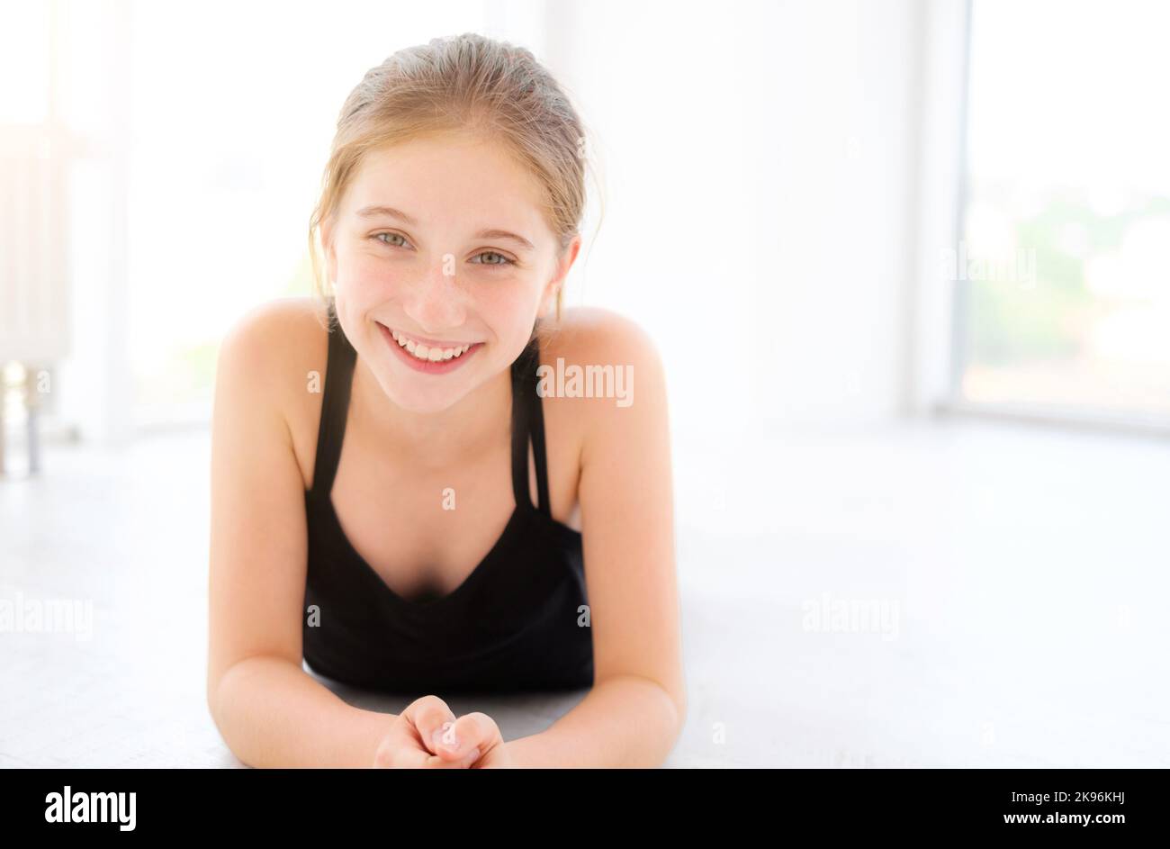 Cute teenager girl lying on a floor Stock Photo - Alamy