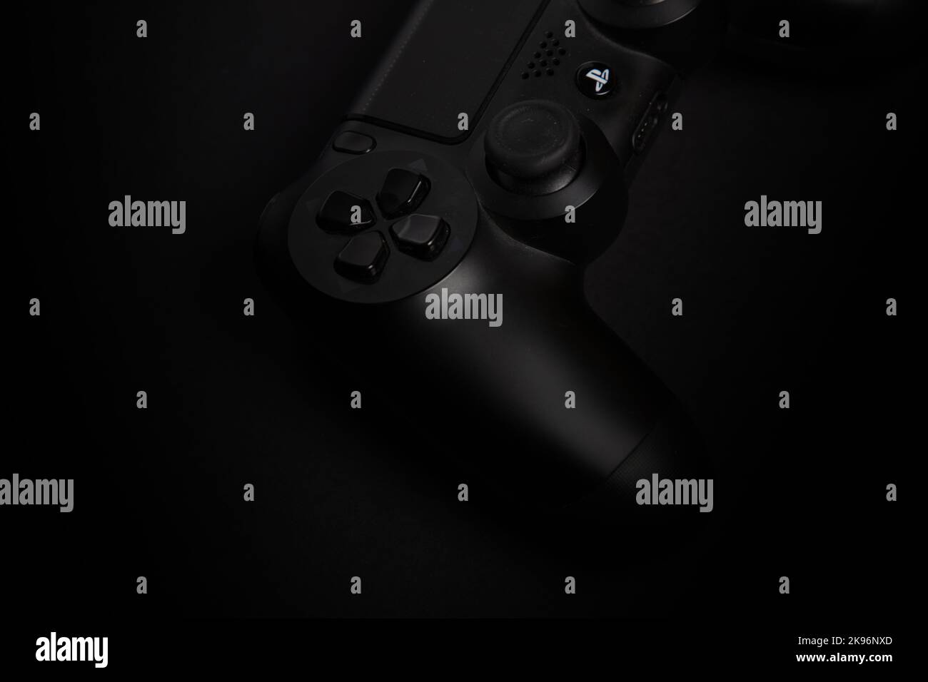 a detail shot of a playstation gaming joypad on a black, dark background, professional studio shot Stock Photo