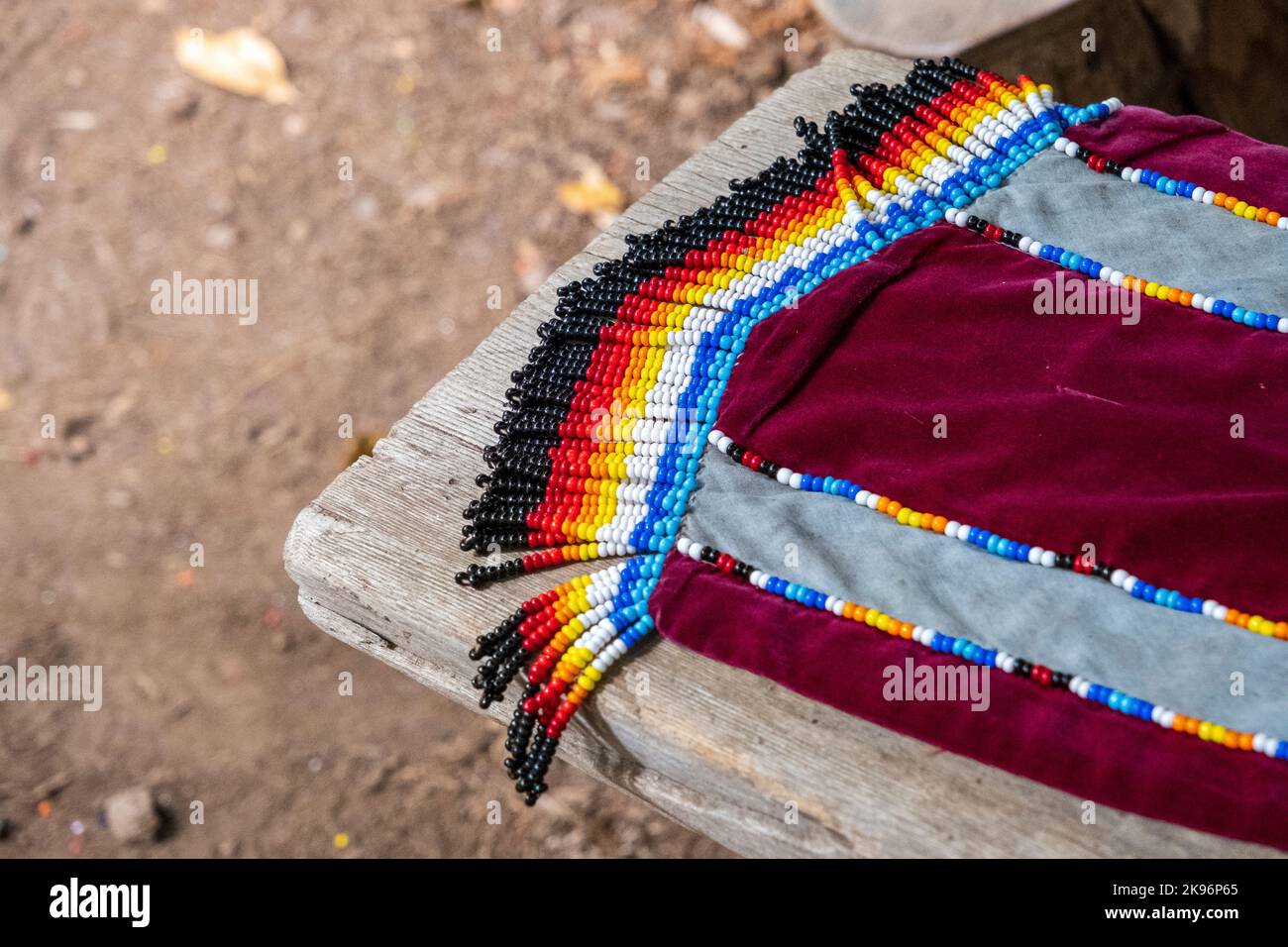 Colorful native American beadwork has been added to a crimson, velvet scarf. Stock Photo