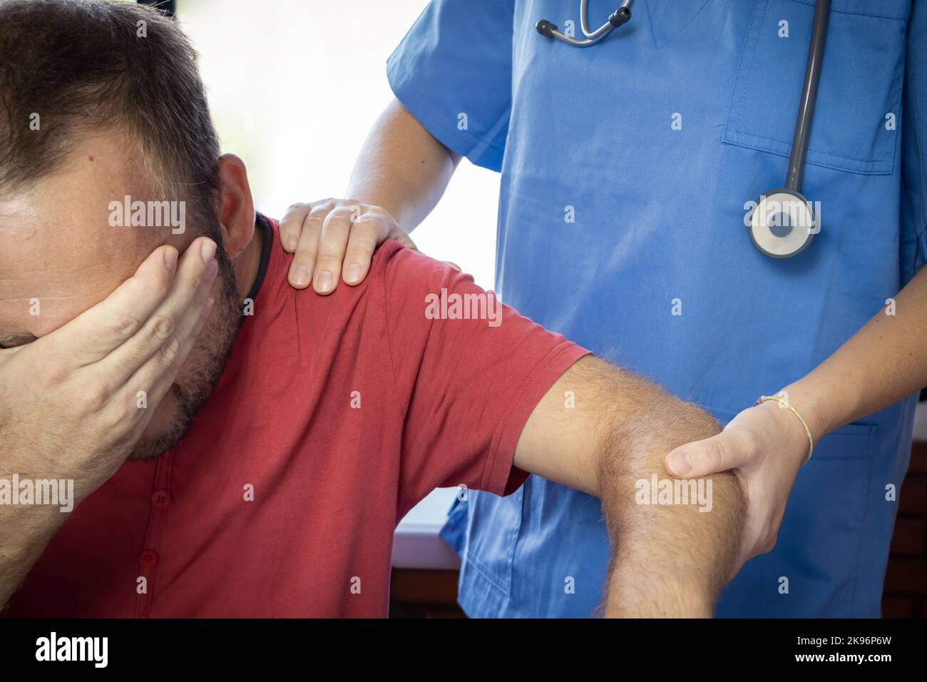 nurse or sanitary exploring arm injury, dislocated shoulder of the patient Stock Photo Alamy