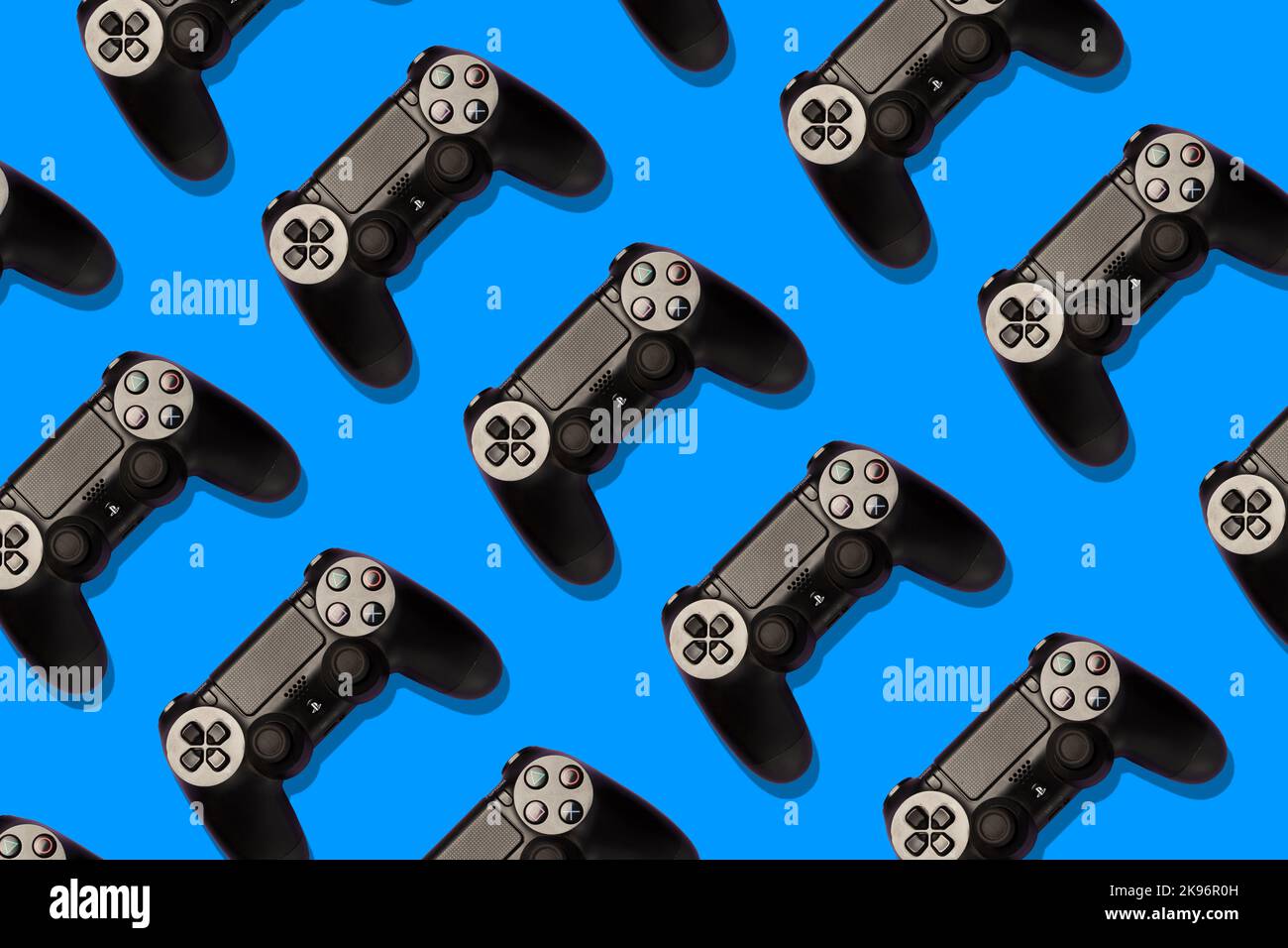 playstation joypads on a colourful background, repetition, pop, professional studio shot Stock Photo