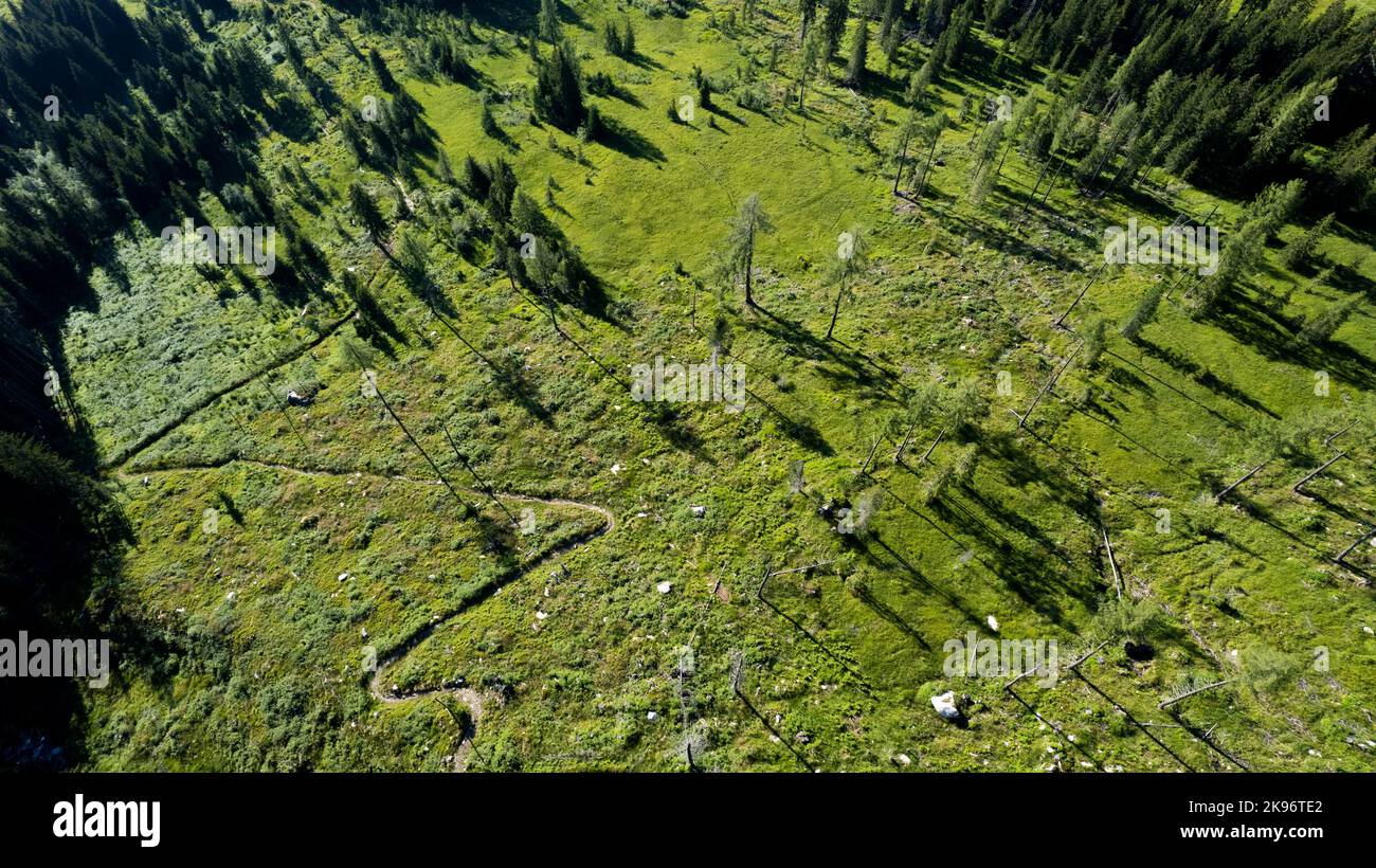 An aerial view of the trail in green mountains on a sunny day Stock ...