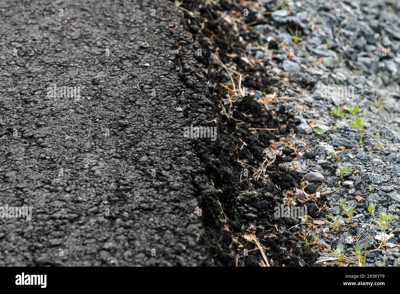 The edge between new asphalt road and a roadside. Abstract transportation background photo with selective soft focus Stock Photo