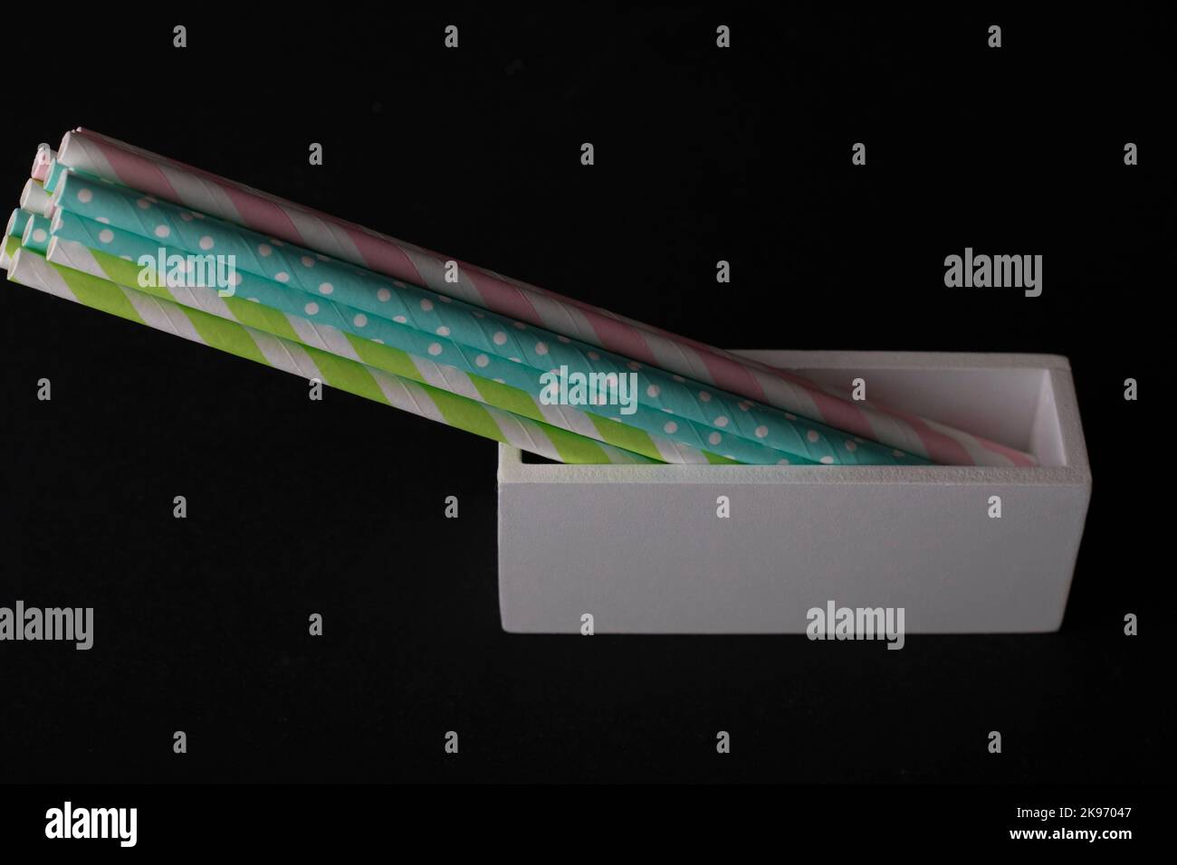 Multicolored cocktail straws on a black background Stock Photo
