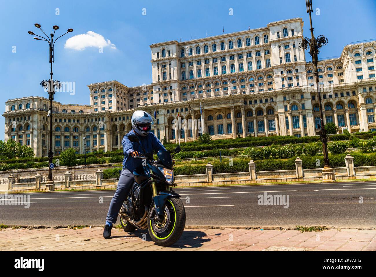 Biker on a motorcycle in traffic at rush hour in downtown area of the