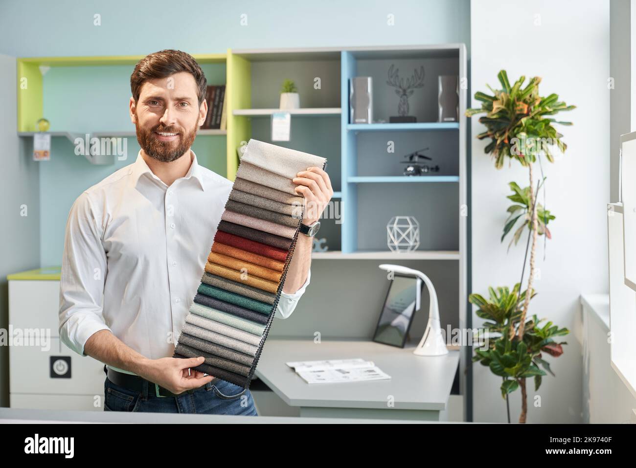 Professional male sales manager demonstrating various samples of