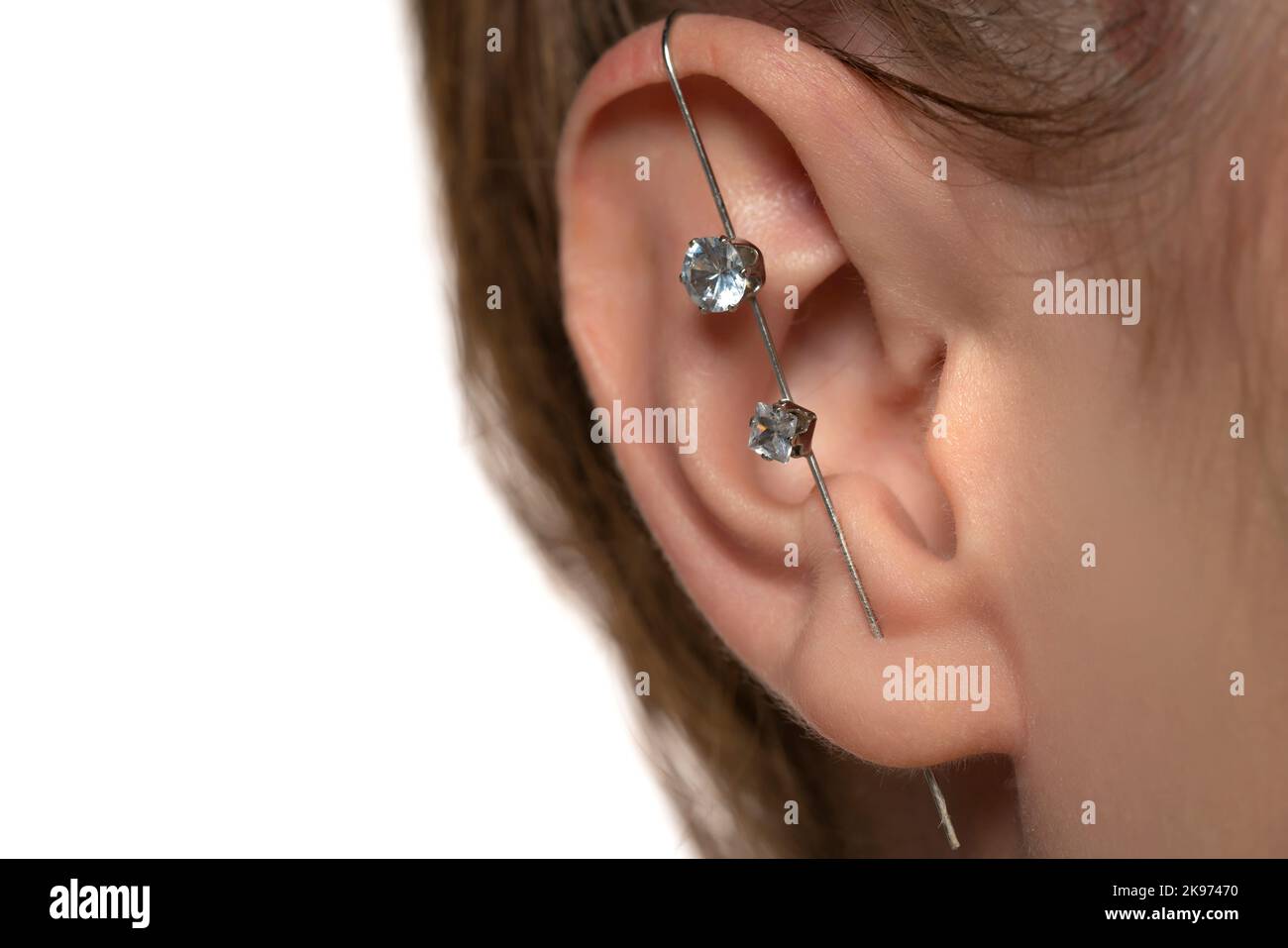 female ear piercing without drilling the helix. Stock Photo