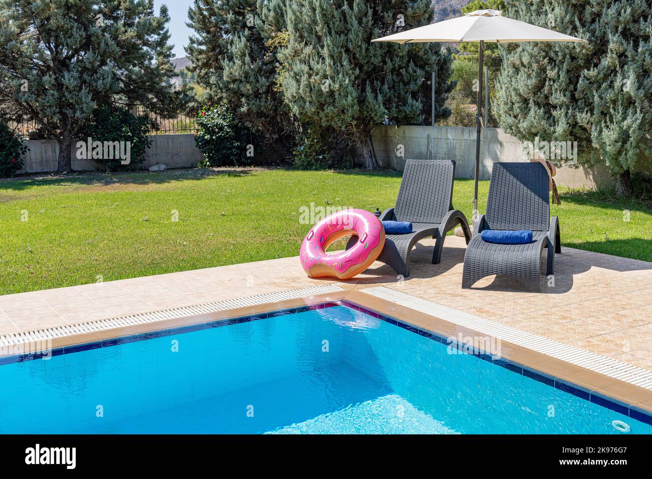 A swimming pool and deck with an inflatable donut Stock Photo