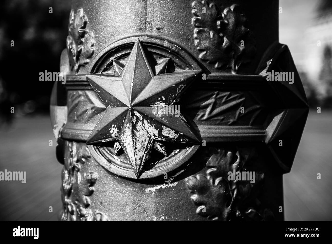 A closeup grayscale shot of star symbol on metal Stock Photo