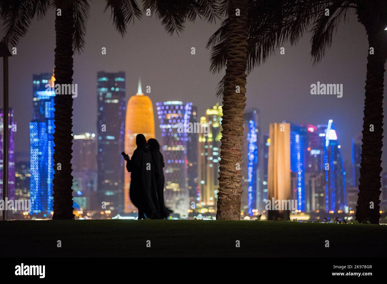 Doha, Qatar- October 23,2022 :Qatari on a night walk in the park of the Museum of Islamic Art. Stock Photo
