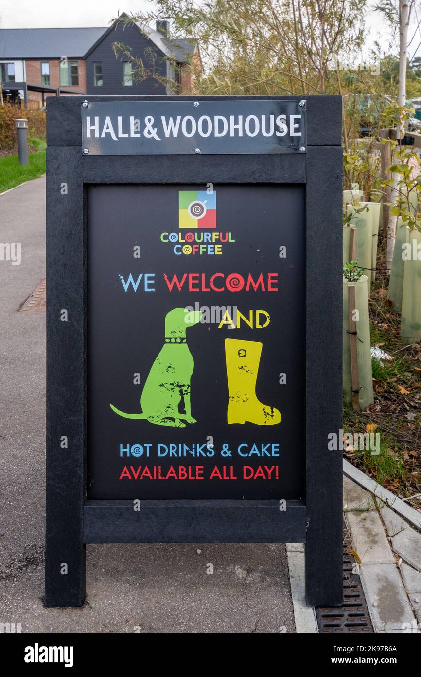Hall & Woodhouse pub A-board sign advertising Colourful Coffee hot drinks and cake, and saying we welcome dogs and boots with pictures Stock Photo