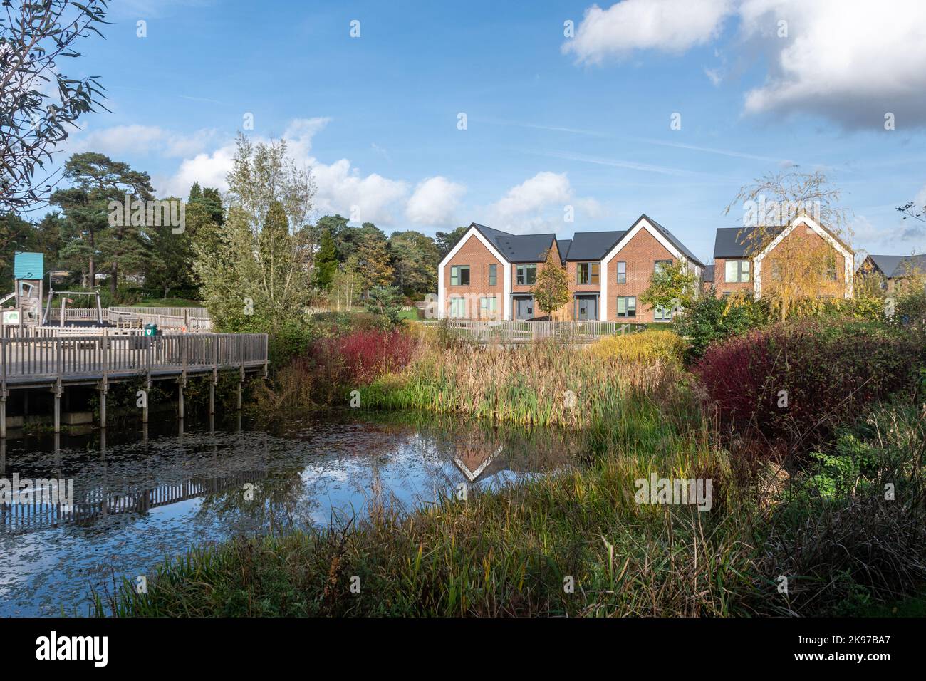 New housing development called Mindenhurst in Deepcut village, Surrey, England, UK, in 2022. Trivselhus Scandi style houses and pond. Stock Photo