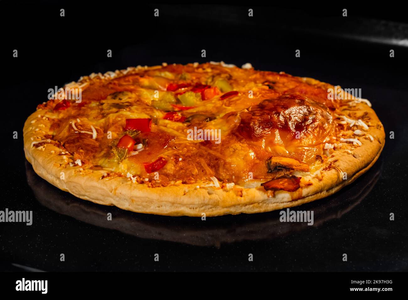 Burnt homemade pizza on tray in electric oven, black background Stock Photo Alamy