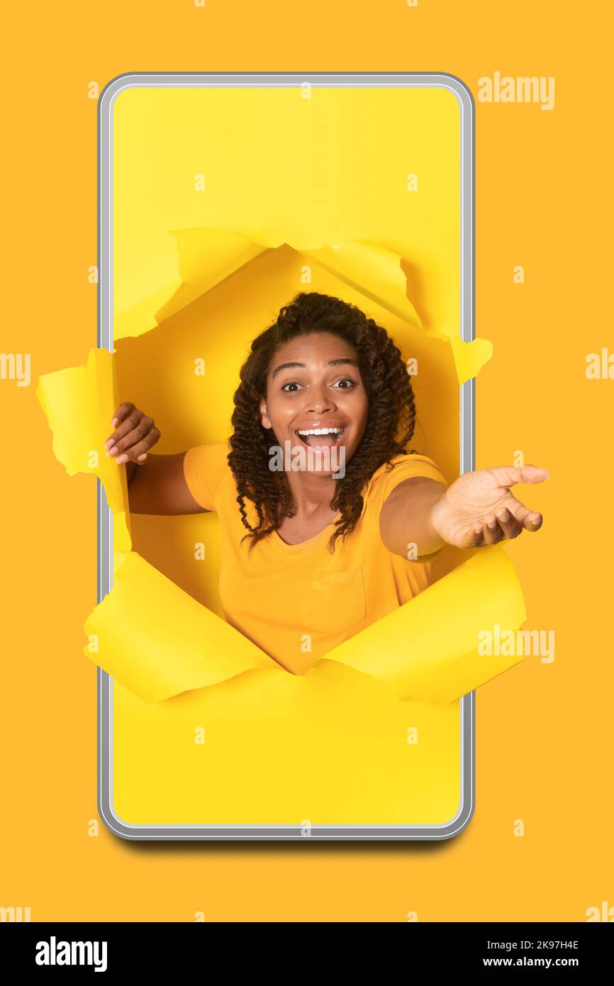 Excited Black Lady In Cellphone Stretching Hand Through Hole, Studio ...