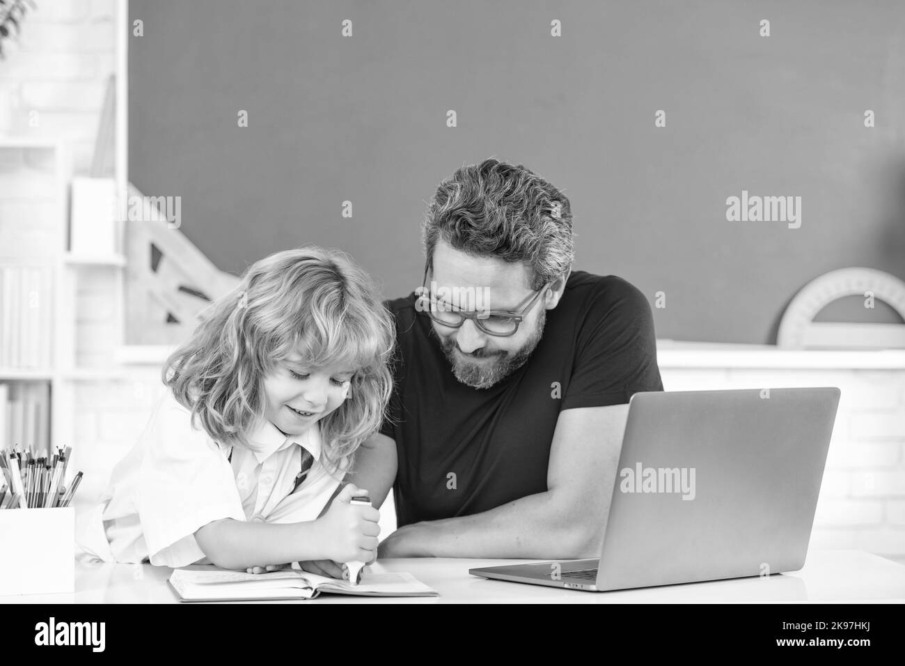 father and child study in classroom with laptop, knowledge Stock Photo