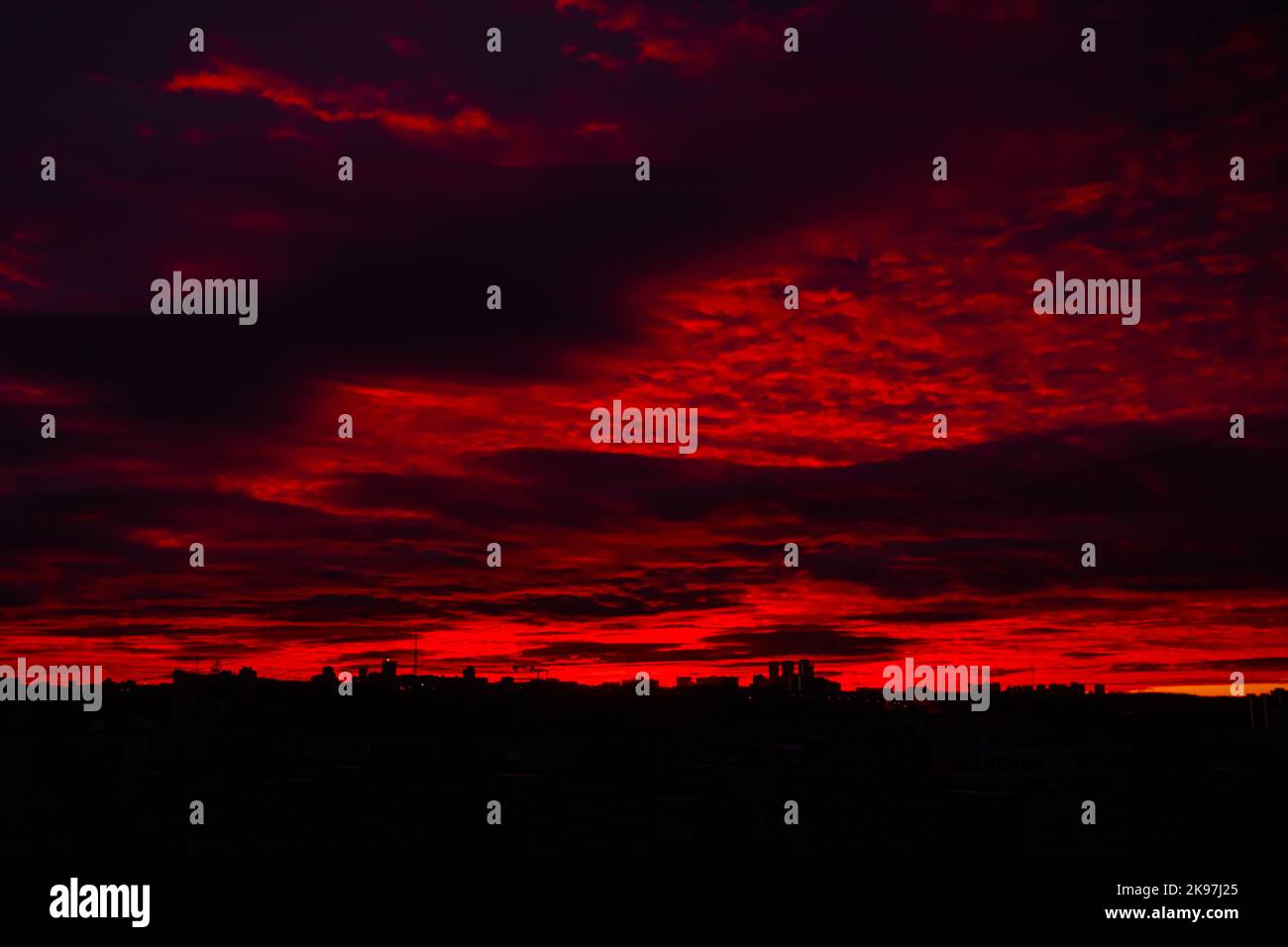 Colorful red sunrise over city and dramatic sky with clouds Stock Photo ...